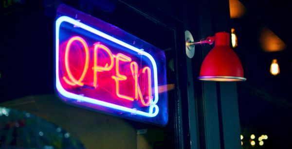 Neon "Open" sign in a window, symbolizing access to private markets in defined contribution plans