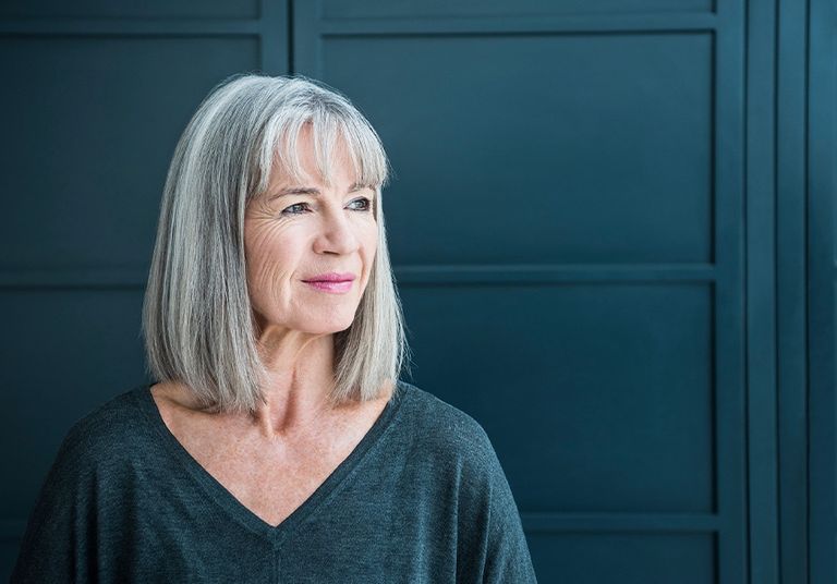 Middle-aged woman gazing into the distance.