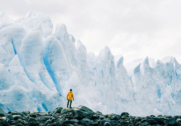 Man in front of iceberg