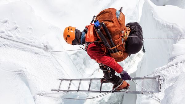 Man cascading down ladder while snow shoeing