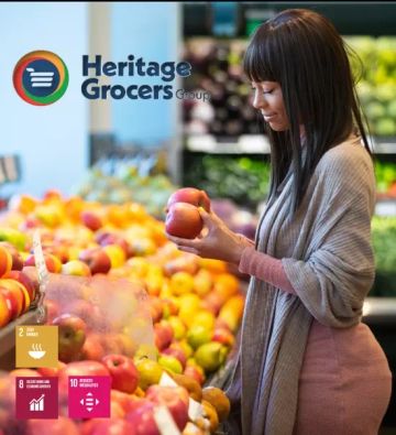 Women picking apples at the produce section of the supermarket 