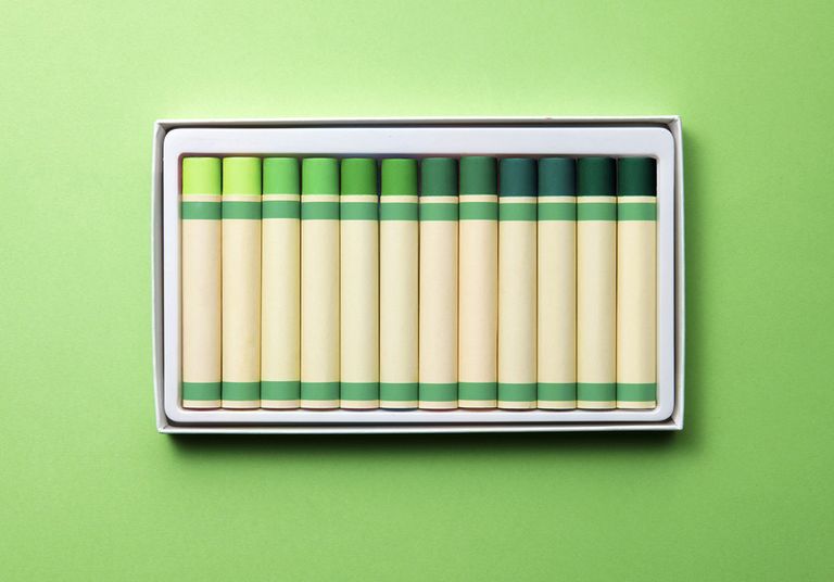various shades of green crayons behind a green background