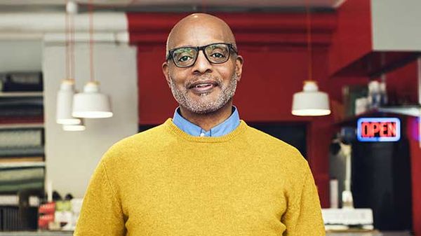 A man smiles confidently, symbolizing a bright future through smart retirement investments.