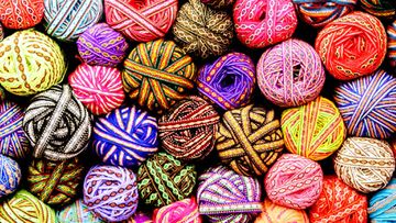 image of several balls of multi-colored yarn.