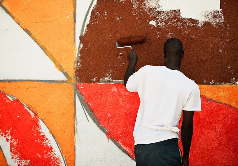 A man paints a mural