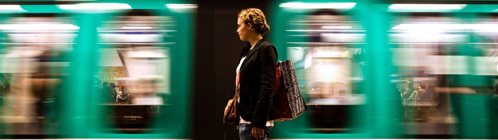 A person strides in front of a train, representing the retirement journey and the importance of using custom or investable benchmarks.