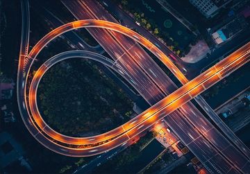 Aerial view of a brightly lit highway interchange at night