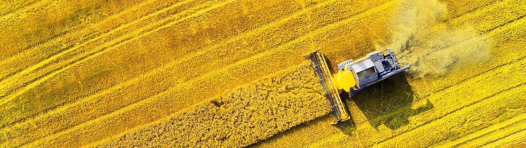A combine harvester in a field illustrates the harvest of profits, similar to the income generated through securities lending