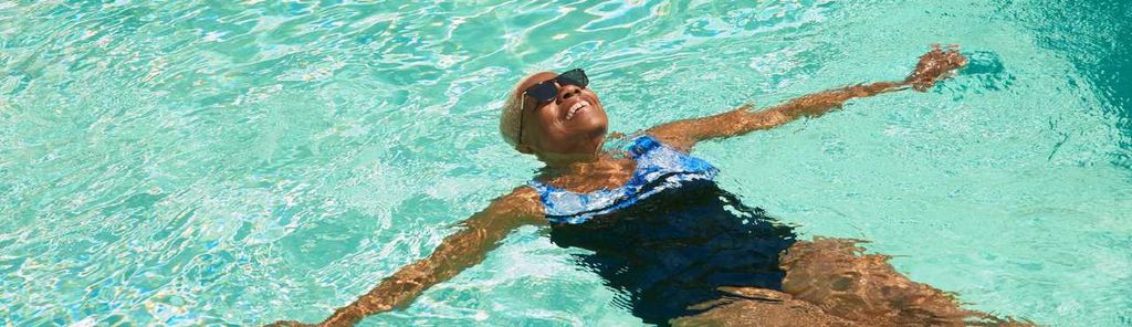 A woman floating in a pool, embodying the relaxation and freedom that comes with retirement