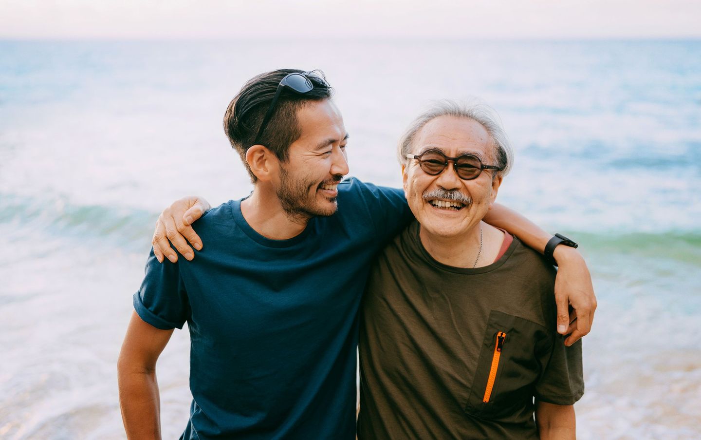 two happy men with their arm around one another