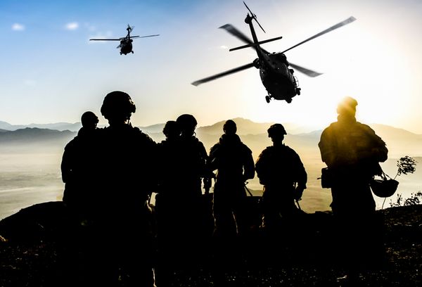 Silhouettes of soldiers during Military Mission at dusk