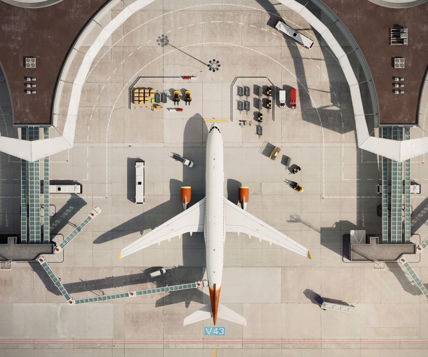 Aerial view of a commercial airplane at airport gate, with ground service vehicles and personnel surrounding it.